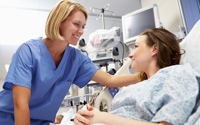 Young Female Patient Talking To Nurse In Emergency Room